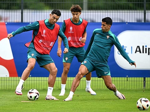 (From left) Portugal's forward Cristiano Ronaldo, forward Joao Felix and defender Joao Cancelo attend a MD-1 training session at the team's base camp in Harsewinkel on Thursday.