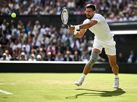 Serbia's Novak Djokovic returns the ball to Britain's Jacob Feamley during their men's singles tennis match on the fourth day of the 2024 Wimbledon Championships at The All England Lawn Tennis and Croquet Club in Wimbledon, southwest London, on Thursday.