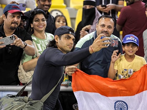 India's Neeraj Chopra takes a selfie with fans after the men's javelin throw final during the IAAF Diamond League competition on May 10, 2024 at the Suheim Bin Hamad Stadium in Doha.
