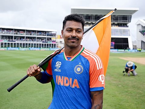 All-rounder Hardik Pandya holds the Indian flag after team's win over South Africa in the final last Saturday.