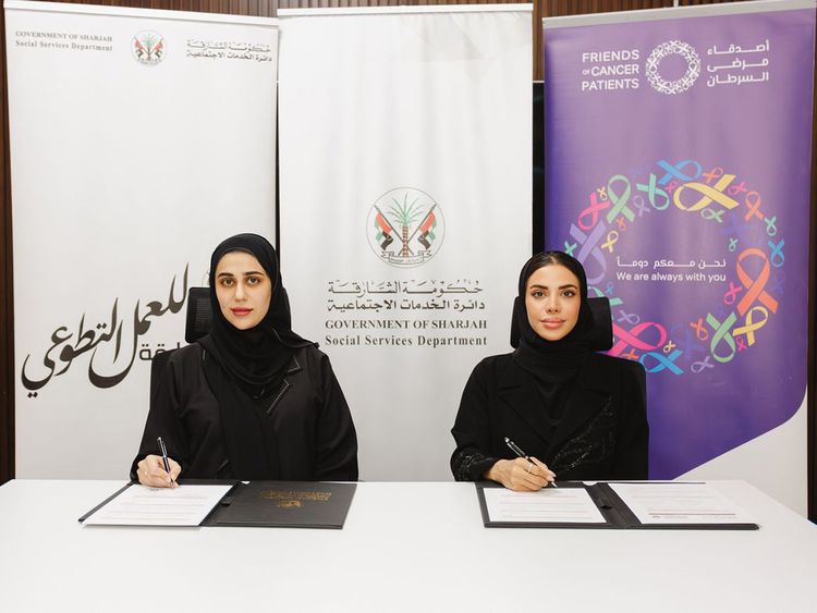 Hessa Al Hammadi (L), director of the Community Cohesion Department at SSSD, and Aisha Al Mulla, director of FOCP, during the signing of the partnership agreement