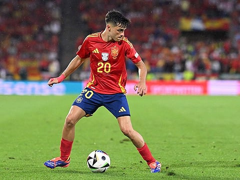 Spain's midfielder #20 Pedri controls the ball.