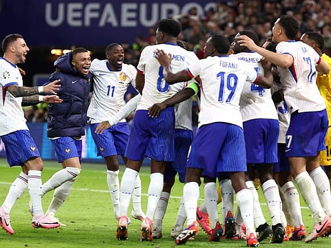 TOPSHOT - France's forward Ousmane Dembele (3rd L) and forward Kylian Mbappe (2nd L) celebrate with teammates after winning the Uefa Euro 2024 quarter-final football match against Portugal in Hamburg on July 5.