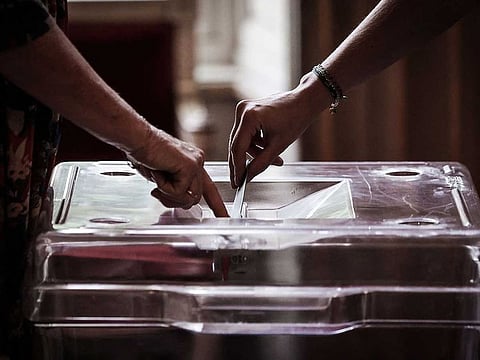 A voter casts ballot during the second round of France's crunch legislative elections at a polling station in Bordeaux, south-western France on July 7, 2024.
