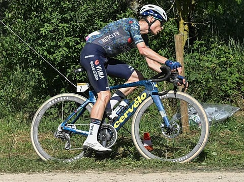 Team Visma - Lease a Bike team's Danish rider Jonas Vingegaard cycles over a "Chemin Blanc" (white road) gravel sector during the 9th stage of the 111th edition of the Tour de France cycling race on Sunday.