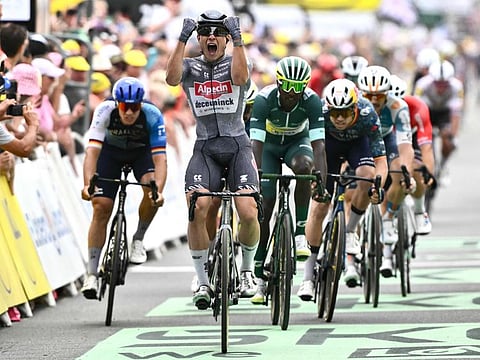 Alpecin-Deceuninck team's Belgian rider Jasper Philipsen (centre) cycles past the finish line to win ahead of second-placed Intermarche - Wanty team's Eritrean rider Biniam Girmay (R) and third-placed Israel - Premier Tech team's German rider Pascal Ackermann (L) during the 10th stage of the 111th edition of the Tour de France cycling race, 187,3 km between Orleans and Saint-Amand-Montrond, central France, on Tuesday.