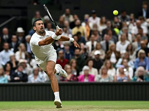 Serbia's Novak Djokovic in action against Denmark's Holger Rune during their men's singles tennis match of the 2024 Wimbledon Championships at The All England Lawn Tennis and Croquet Club in Wimbledon.
