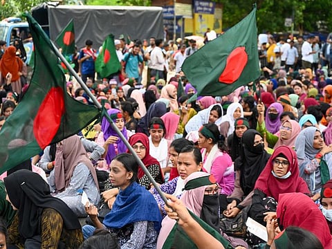 Students block roads as they protest to demand a merit-based system for civil service jobs in Dhaka on July 10, 2024.