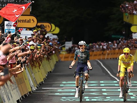 Team Visma - Lease a Bike team's Danish rider Jonas Vingegaard cycles to the finish line to win ahead of UAE Team Emirates team's Slovenian rider Tadej Pogacar wearing the overall leader's yellow jersey the 11th stage of the 111th edition of the Tour de France cycling race on Wednesday.