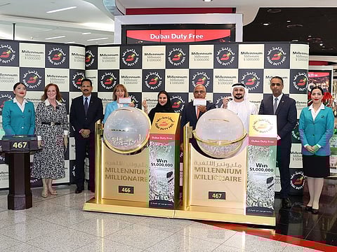DDF representatives with the two tickets that won $1 million at the airport on Wednesday
