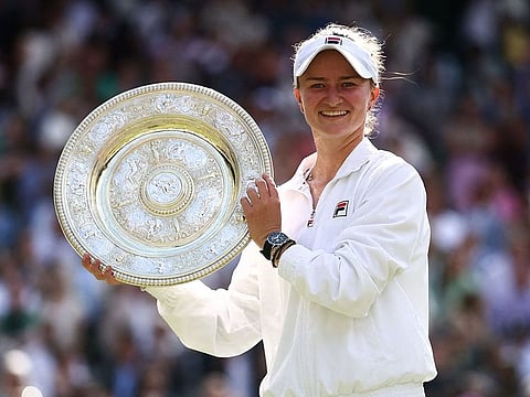 Czech Republic's Barbora Krejcikova poses with the winner's trophy, the Venus Rosewater Dish.