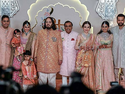 Billionaire tycoon and Chairman of Reliance Industries Mukesh Ambani (C), wife Nita Ambani (3R) daughter Isha Ambani (2R), sons Akash Ambani (L) and Anant Ambani (C, left), daughter-in-law Shloka Mehta (2L), and son-in-law Anand Piramal pose for photos as they arrive to attend the wedding ceremony of Anant and Radhika Merchant in Mumbai on July 12, 2024.