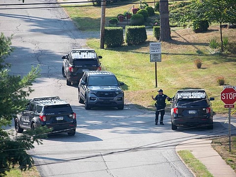 Local police block off roads surrounding the home of the suspected shooter of Trump, as the FBI carries out an investigation, in Bethel Park, Pennsylvania, on July 14, 2024. The alleged shooter was killed by law enforcement officials after he fired an AR-15-type semiautomatic rifle, killing one spectator and wounding others.