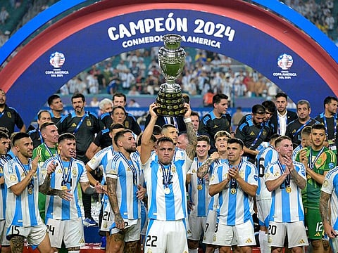 Argentina's forward #22 Lautaro Martinez lifts up the trophy as he celebrates winning the Conmebol 2024 Copa America tournament final football match between Argentina and Colombia at the Hard Rock Stadium, in Miami.