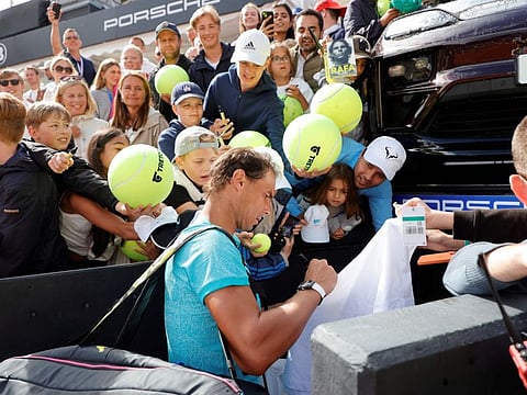 Spain's Rafael Nadal signs autographs after winning the men's doubles tennis match with Norway's Casper Ruud during the Nordea Open ATP tennis tournament in Bastad, Sweden, on Monday.