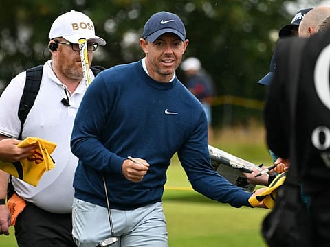 Northern Ireland's Rory McIlroy signs autographs for fans during a practice round ahead of the 152nd British Open Golf Championship at Royal Troon on the south west coast of Scotland on Tuesday.