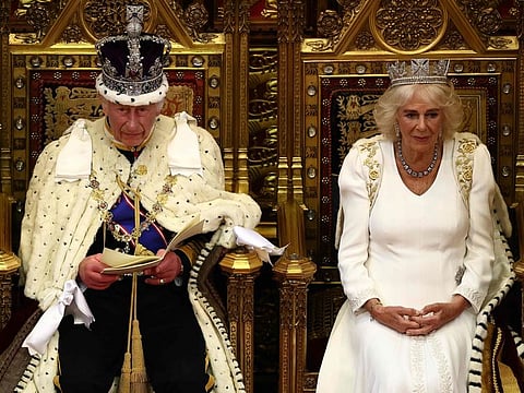 Britain's King Charles III sits alongside Britain's Queen Camilla, wearing the George IV State Diadem, as he reads the King's Speech from the The Sovereign's Throne in the House of Lords chamber, during the State Opening of Parliament in London, on July 17, 2024.