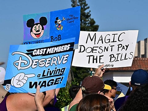 Disney cast members rally outside the main entrance of Disneyland Resort in Anaheim, California.