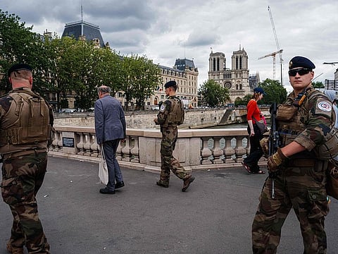 French soldiers from the Operation Sentinelle patrol on Petit Pont - Cardinal Lustiger bridge.