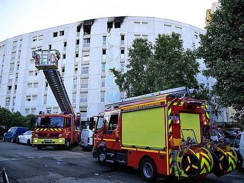 French Firefighters veichles stopped in front of a building after extinguishing a fire that broke out overnight.