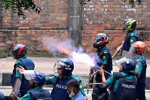 Bangladesh police fire tear shells to disperse anti-quota protesters during a clash in Dhaka on July 18, 2024.