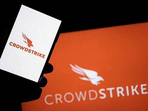 This photo illustration shows screens displaying logos of ‘CrowdStrike’, American cybersecurity technology company. Airlines, banks, TV channels and other business across the globe were scrambling to deal with one of the biggest IT crashes in recent years on July 19, 2024, caused by an update to an antivirus program.