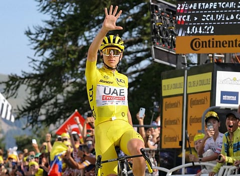 UAE Team Emirates team's Slovenian rider Tadej Pogacar cycles to the finish line to win the 20th stage of the 111th edition of the Tour de France cycling race on Saturday.