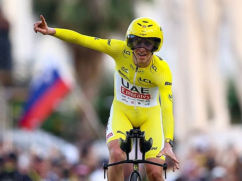 UAE Team Emirates team's Slovenian rider Tadej Pogacar wearing the overall leader's yellow jersey celebrates as he crosses the finish line to win the 21st and final stage and the overall victory in the 111th edition of the Tour de France cycling race on Sunday.