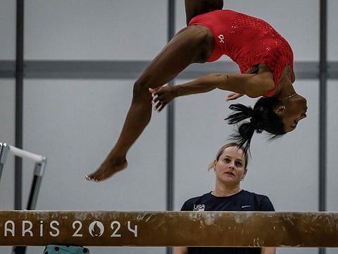 A US' coach watches as Simone Biles takes part in a training session at the Gymnastics training centre in Le Bourget, on Sunday.