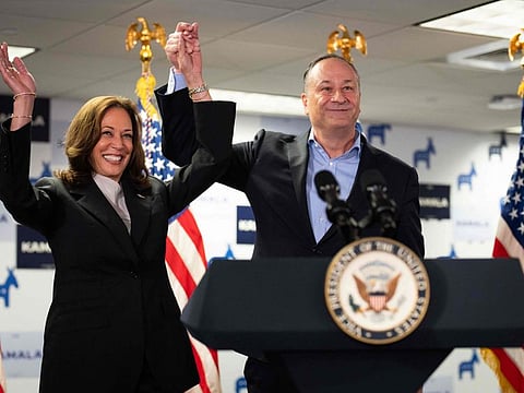 US Vice President and Democratic presidential candidate Kamala Harris and Second Gentleman Doug Emhoff acknowledge the crowd before speaking at her campaign headquarters in Wilmington, Delaware, on July 22, 2024.