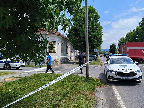 Police cars are stationed in front of a care home where at least six people were killed in a shooting in Daruvar, some 130km from Zagreb on July 22, 2024.