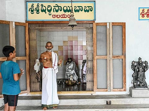 Hindu priest Subhramanya Sharma (right) prays for the victory of Usha Vance's husband JD Vance, US Senator from Ohio and 2024 Republican vice presidential candidate, at a Sai Baba temple in Vadluru, ancestral village of Usha's parents at the West Godavari district of India's Andhra Pradesh state on July 23, 2024.