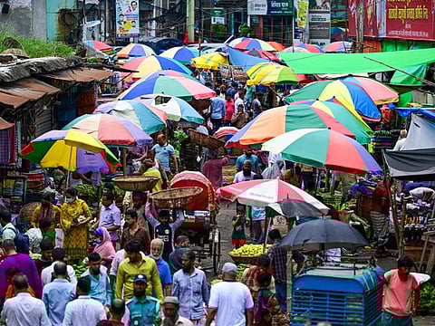 People shop at a market as the curfew is relaxed after the anti-quota protests in Dhaka on July 25, 2024.