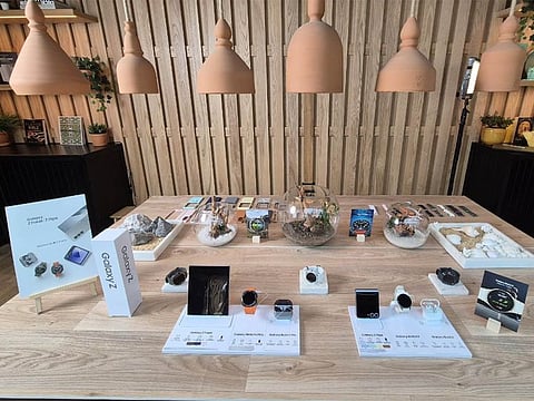 New Samsung Galaxy Z Fold6 and Flip6 phones along with watches and buds on display at the event.