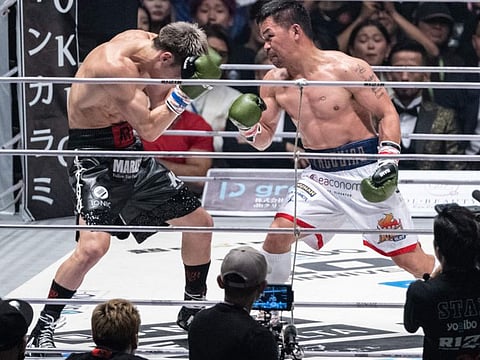 Philippines boxing legend Manny Pacquiao (right) fights against Japanese mixed martial artist Rukiya Anpo during their three-round exhibition boxing match at Saitama Super Arena in Saitama on Sunday.