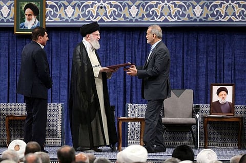 Khamenei (centre) delivers the official endorsement letter to president elect Masoud Pezeshikan during the new president endorsement ceremony on July 28, 2024.