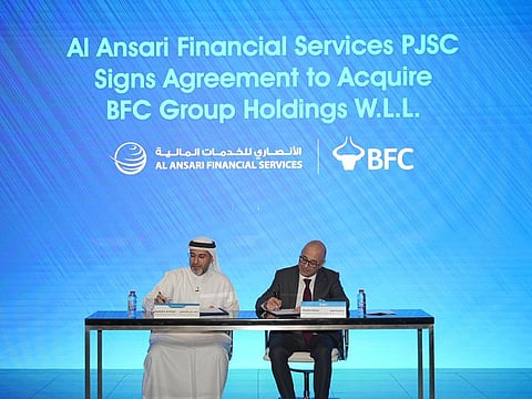 Rashed Ali Al Ansari, Group CEO of Al Ansari Financial Services, and Ebrahim Nonoo, Managing Director and CEO of BFCGH, signing the agreement
