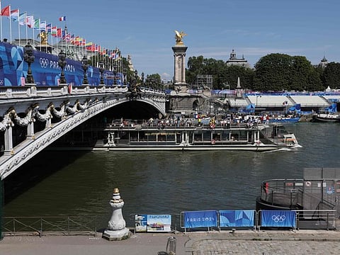 A tourist boat navigates on the Seine river under the Alexandre III bridge, after the first triathlon training session was cancelled during the Paris 2024 Olympic Games in Paris.