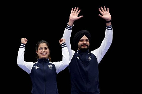 Bronze medalists India's Manu Bhaker and India's Sarabjot Singh celebrate on the podium at the end of the shooting 10m air pistol mixed team event during the Paris 2024 Olympic Games at Chateauroux Shooting Centre on Tuesday.