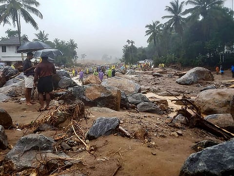 Relief personnel conduct a search and rescue operation at a site following landslides in Wayanad on July 30, 2024.