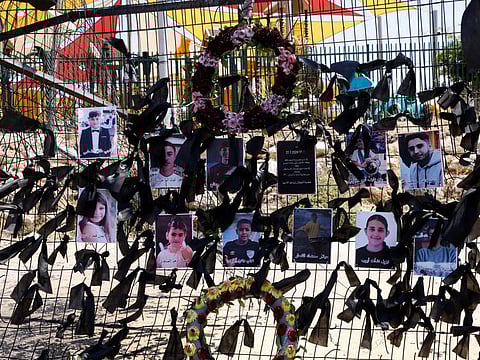 Portraits of the children and youngsters who were killed hang on the football stadium fence where a rocket landed, in the Druze village of Majdal Shams in the Israel annexed Golan Heights on July 29.
