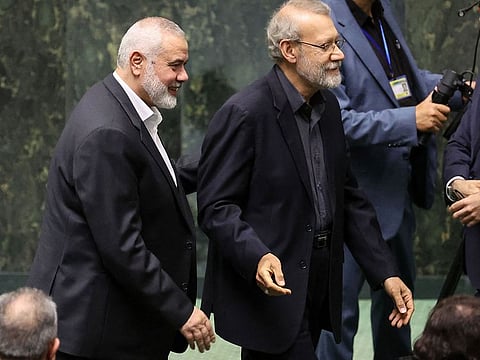 Haniyeh (left) walks next to ex-parliament speaker Ali Larijani during a swearing in ceremony for the new president at the parliament in Tehran, on July 30 2024.  Doha-based Haniyeh, who the day earlier had attended the inauguration of new Iranian President Masoud Pezeshkian, was killed in the early hours of Wednesday at a residence in northern Tehran, according to Iran’s Revolutionary Guards.