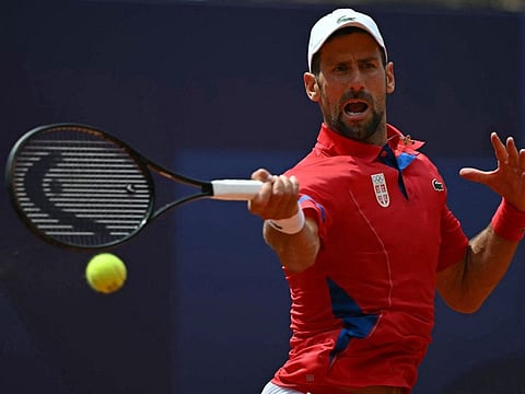 Serbia's Novak Djokovic returns to Germany's Dominik Koepfer during their men's singles third round tennis match on Court Philippe-Chatrier at the Roland-Garros Stadium during the Paris 2024 Olympic Games on Wednesday.