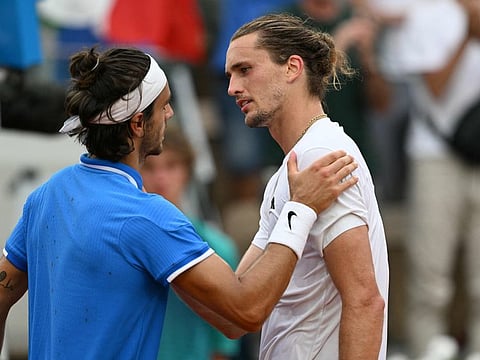 Italy's Lorenzo Musetti (left) consoles Germany's Alexander Zverev after his win in their men's singles quarter-final tennis match on Court Suzanne-Lenglen at the Roland-Garros Stadium during the Paris 2024 Olympic Games, in Paris on Thursday.