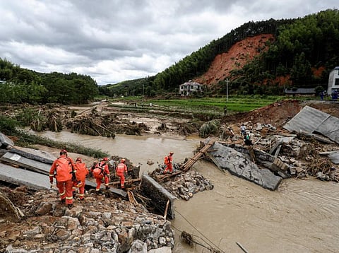 Members of a rescue team walk to a flood-affected area in Zixing, in central China's Hunan province.
