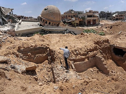 A Palestinian man inspects a dug-up area where the Israeli army reportedly conducted operations before withdrawing in Bani Suhayla town in the east of the Khan Younis governorate in the southern Gaza Strip on July 30, 2024.