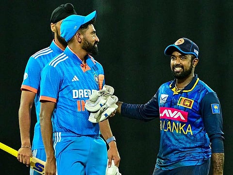 Sri Lanka's captain Charith Asalanka (R) walks past India's Mohammed Siraj (front L) after the first ODI match at the R. Premadasa International Cricket Stadium in Colombo on August 2, 2024.