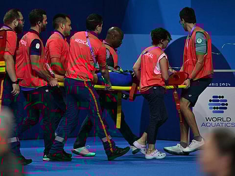 Medical staff carry Slovakia's Tamara Potocka on a stretcher after she collapsed following a heat on Friday.