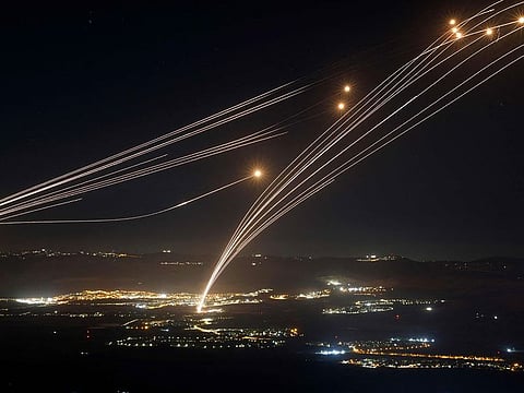 Rockets fired from southern Lebanon are intercepted by Israel's Iron Dome air defence system over the Upper Galilee region in northern Israel, on August 4, 2024, amid ongoing cross-border clashes between Israeli troops and Lebanon's Hezbollah fighters