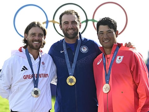 (From L) Silver medallist Britain's Thomas Fleetwood, gold medallist US' Scottie Scheffler and bronze medallist Japan's Hideki Matsuyama pose on the podium at Le Golf National in Guyancourt, south-west of Paris on Sunday.